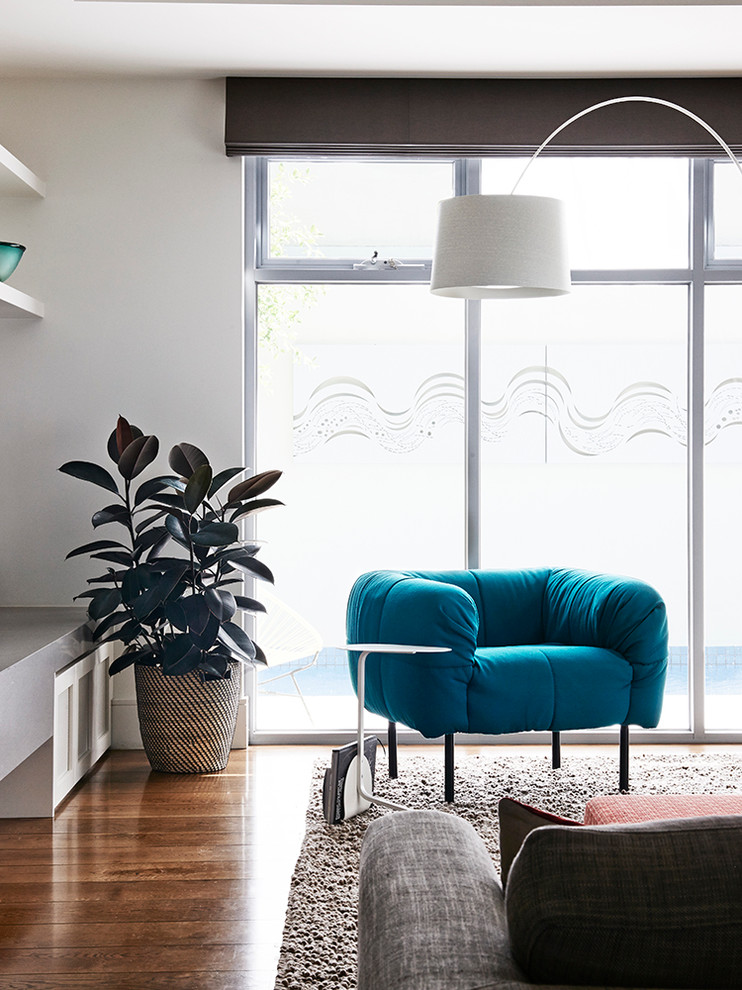 Trendy open concept living room photo in Melbourne with white walls