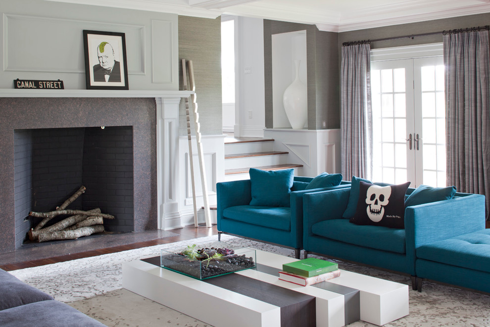 Photo of a contemporary grey and teal living room in New York with grey walls.