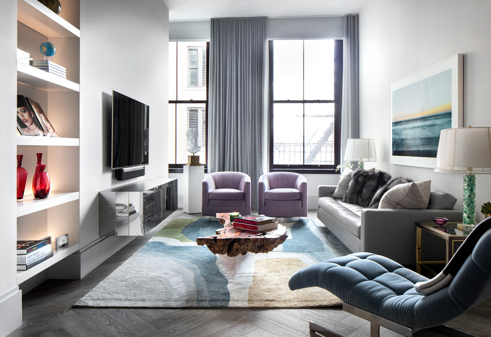 Стильный дизайн: парадная, изолированная гостиная комната в современном стиле с белыми стенами, темным паркетным полом, телевизором на стене и серым полом - последний тренд