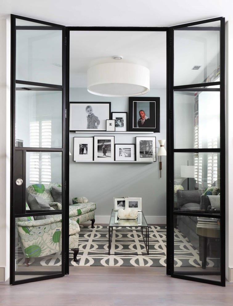 Example of a small trendy enclosed living room design in London with gray walls, no fireplace and no tv