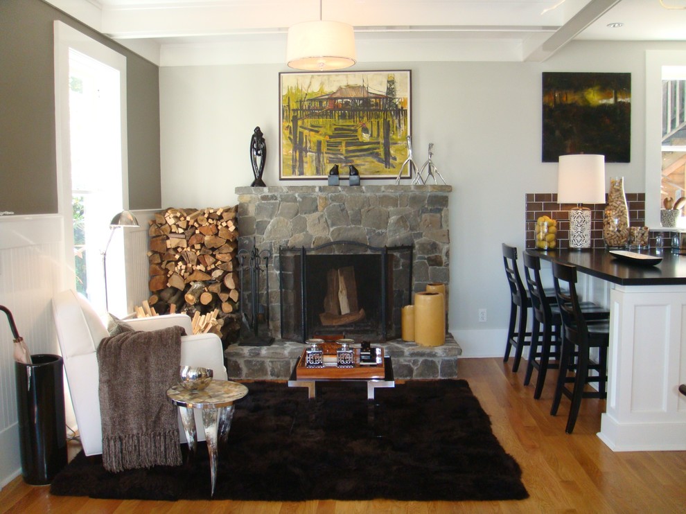 This is an example of a contemporary living room feature wall in San Francisco with a stone fireplace surround.
