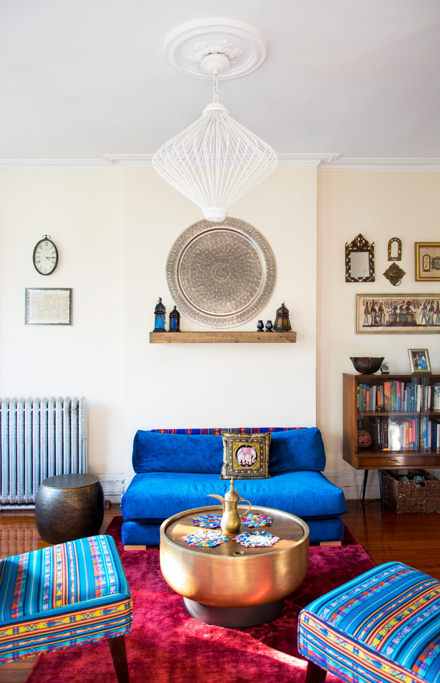 Contemporary living room in New York with beige walls, medium hardwood flooring and brown floors.