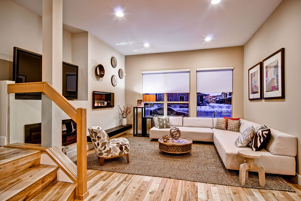 Contemporary living room in Denver with beige walls and a freestanding tv.