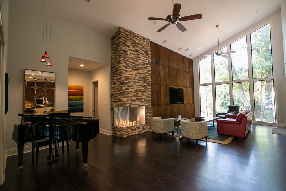 Design ideas for a large contemporary open plan living room in Houston with a music area, grey walls, vinyl flooring, a corner fireplace, a stone fireplace surround and a built-in media unit.
