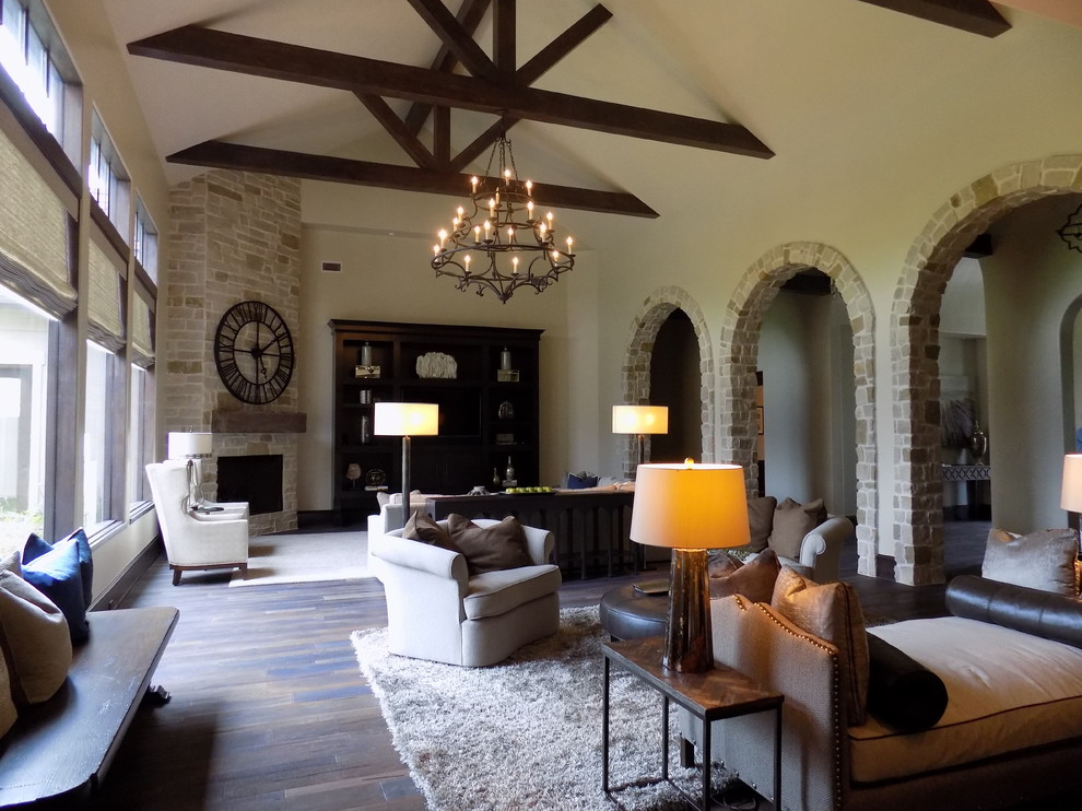 Example of a huge mountain style open concept and formal dark wood floor living room design in Houston with beige walls, a corner fireplace, a stone fireplace and a media wall