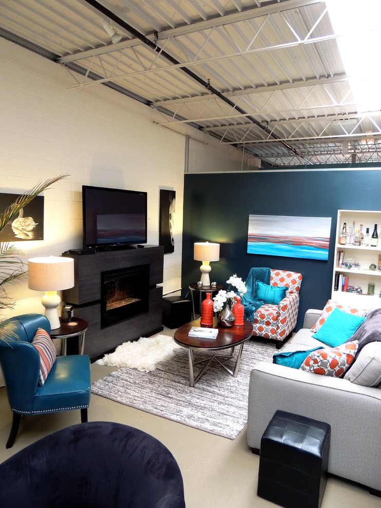 Cette photo montre un petit salon mansardé ou avec mezzanine tendance avec un mur bleu, sol en béton ciré, une cheminée ribbon, un manteau de cheminée en bois et un téléviseur indépendant.