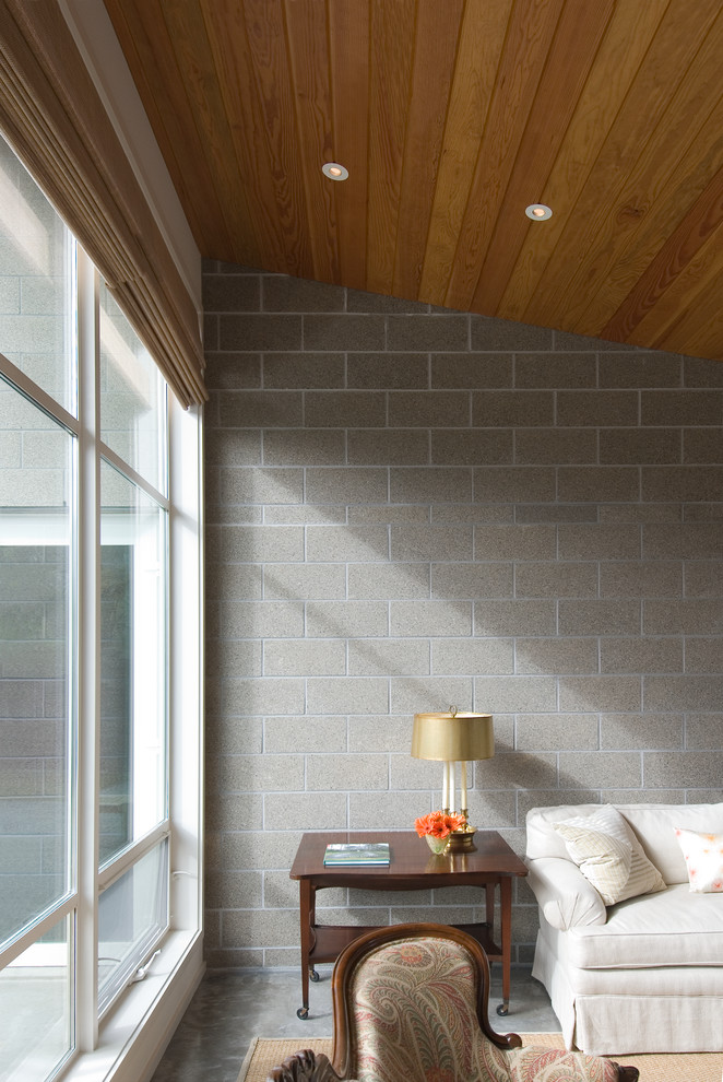 Immagine di un soggiorno contemporaneo chiuso con pareti grigie e pavimento in cemento