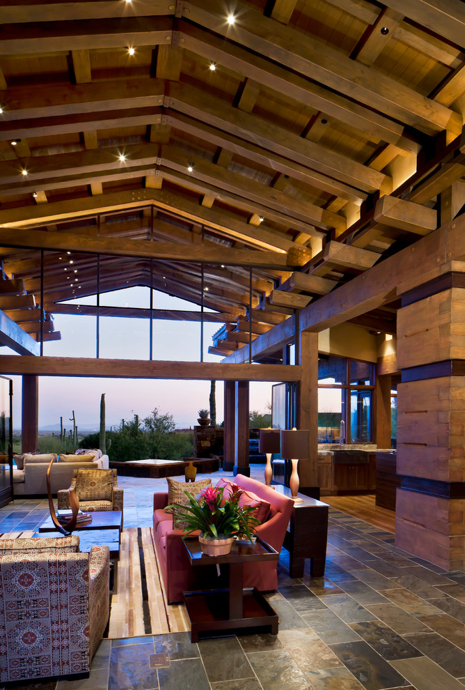 Contemporary open plan living room in Phoenix with slate flooring.
