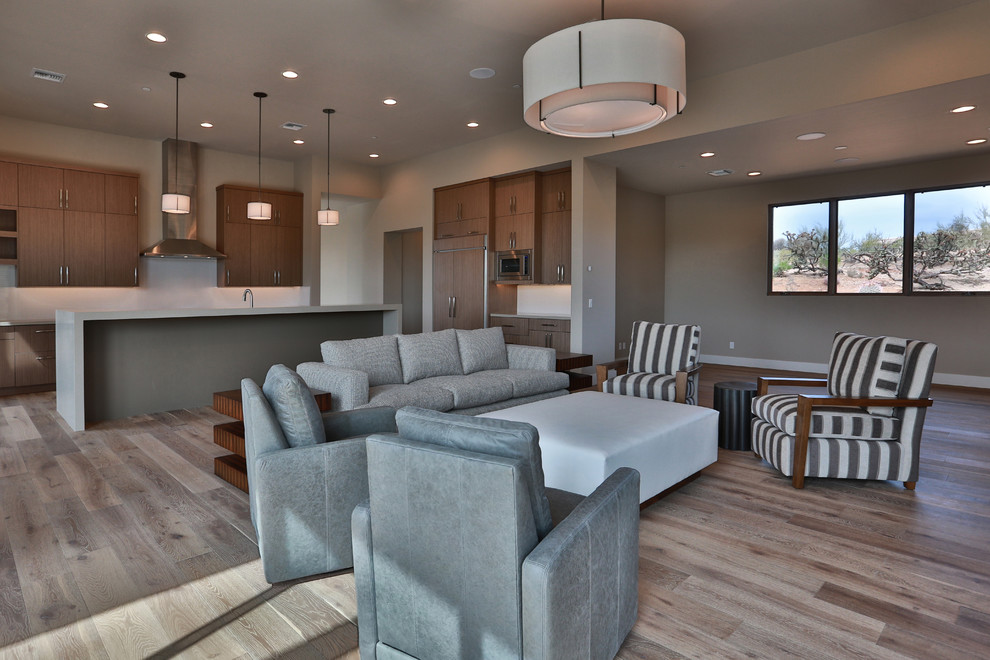 Photo of a large contemporary open plan living room in Phoenix with beige walls and medium hardwood flooring.