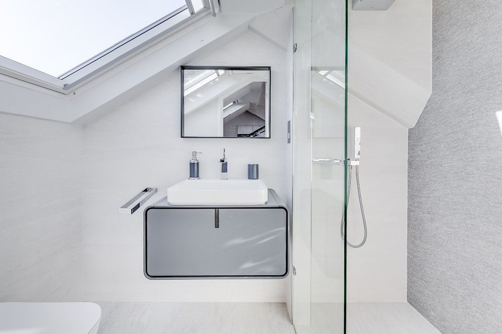 Inspiration for a contemporary shower room bathroom in London with flat-panel cabinets, grey cabinets, a corner shower, grey tiles, white walls, a vessel sink, white floors, an open shower and grey worktops.
