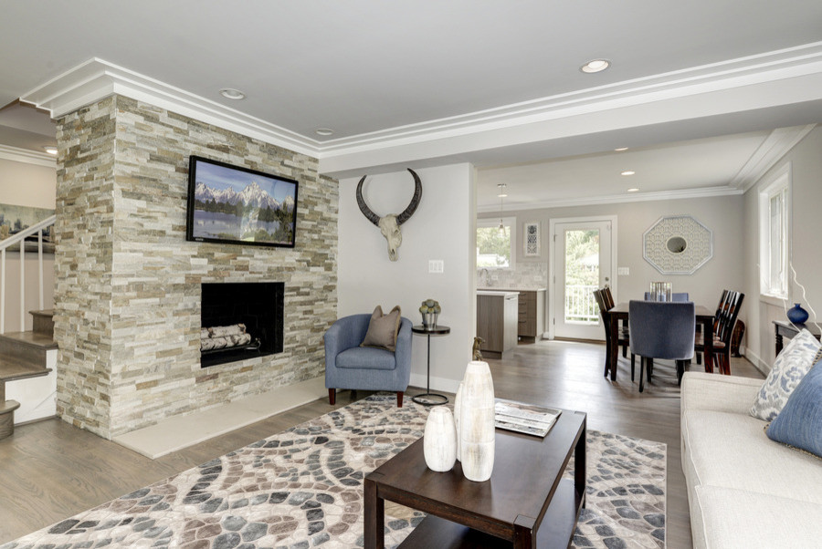 Photo of a medium sized contemporary formal open plan living room in DC Metro with beige walls, light hardwood flooring, a standard fireplace, a stone fireplace surround and a wall mounted tv.