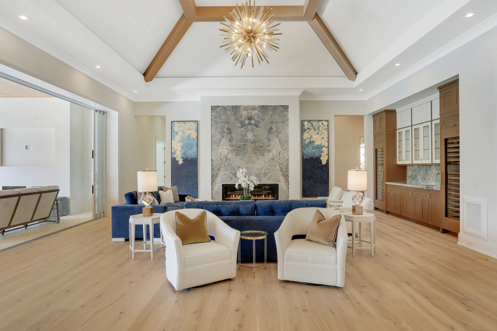 Inspiration for an expansive classic formal open plan living room in Miami with white walls, light hardwood flooring, a standard fireplace, no tv and exposed beams.