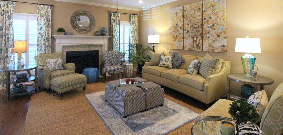 Exemple d'un salon tendance de taille moyenne et ouvert avec une salle de réception, un mur jaune, un sol en bois brun, une cheminée standard, un manteau de cheminée en carrelage, aucun téléviseur et un sol marron.