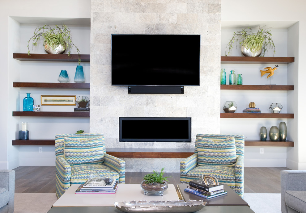 高級な広いコンテンポラリースタイルのおしゃれなリビング (白い壁、磁器タイルの床、横長型暖炉、石材の暖炉まわり、壁掛け型テレビ、グレーの床) の写真