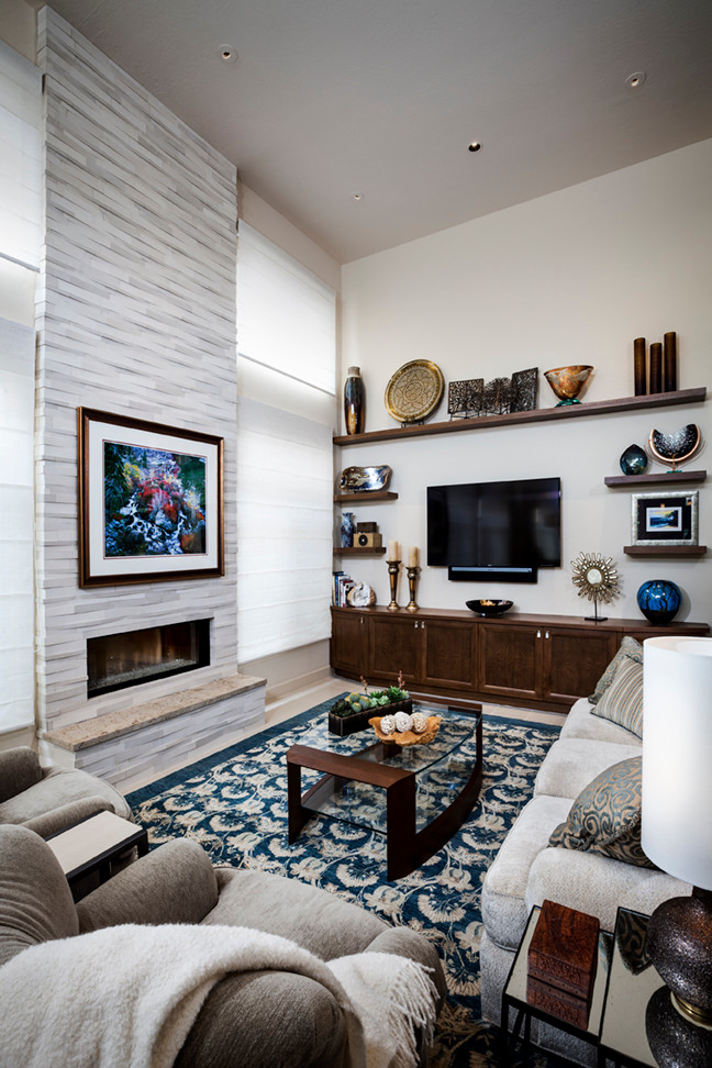 Mid-sized transitional open concept porcelain tile and beige floor living room photo in Phoenix with beige walls, a ribbon fireplace, a stone fireplace and a wall-mounted tv