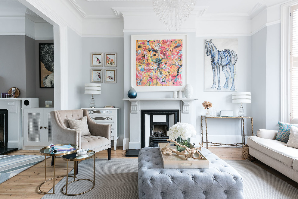 Design ideas for a traditional formal enclosed living room in London with grey walls, light hardwood flooring, a standard fireplace and a metal fireplace surround.