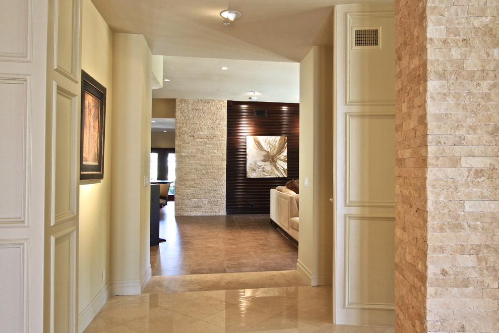 Photo of a large contemporary open plan living room in Orange County with beige walls, no fireplace and porcelain flooring.