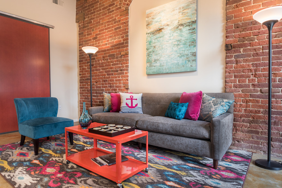 Example of an urban concrete floor living room design in Denver with red walls