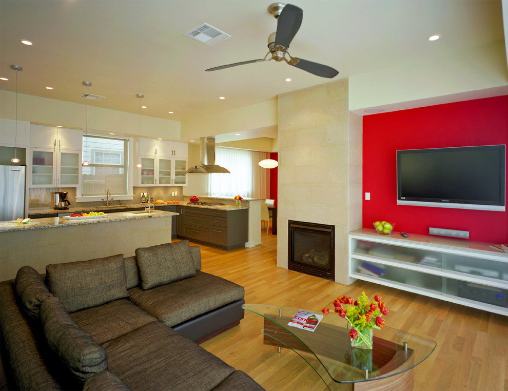 Пример оригинального дизайна: открытая гостиная комната в современном стиле с красными стенами, стандартным камином и акцентной стеной