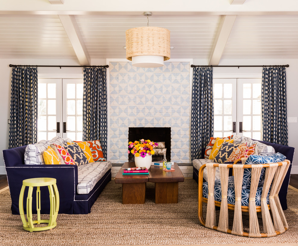 Beach style dark wood floor living room photo in Jacksonville with white walls, a standard fireplace, a brick fireplace and no tv