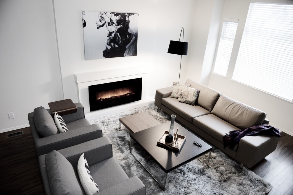 Mid-sized trendy formal and open concept dark wood floor living room photo in Vancouver with a standard fireplace, a concrete fireplace, no tv and white walls