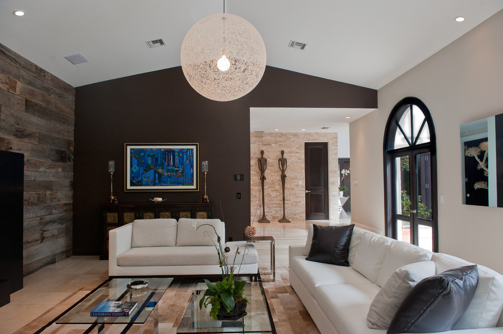 This is an example of a contemporary living room feature wall in Miami with black walls.