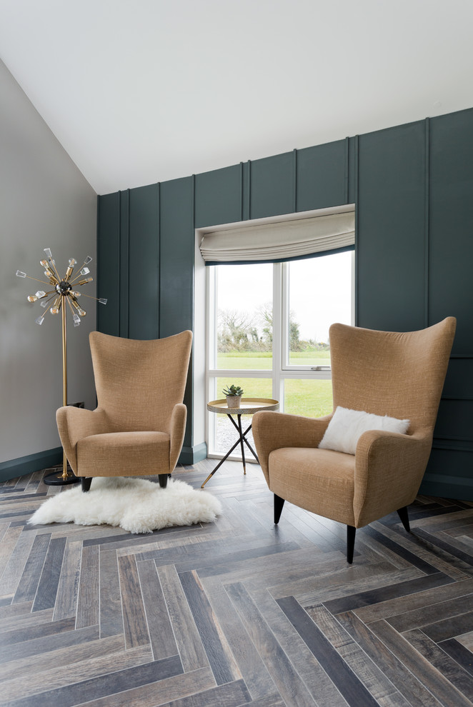 Inspiration for a large contemporary open plan living room in Cork with a reading nook, black walls, ceramic flooring, a standard fireplace, a tiled fireplace surround, no tv and brown floors.