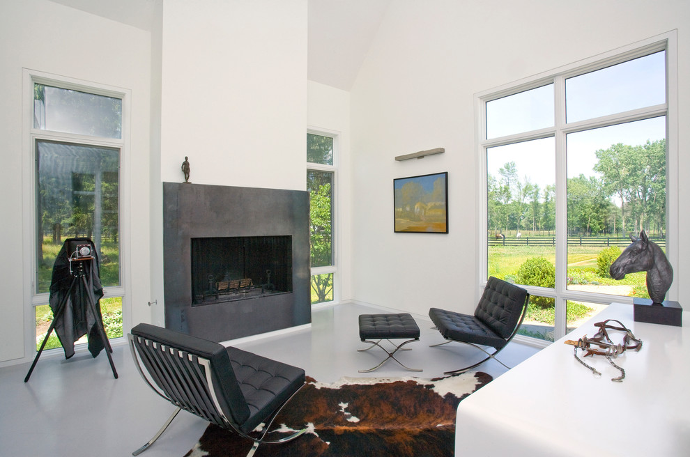 This is an example of a large contemporary open plan living room in Chicago with white walls, concrete flooring, a standard fireplace, a stone fireplace surround and no tv.