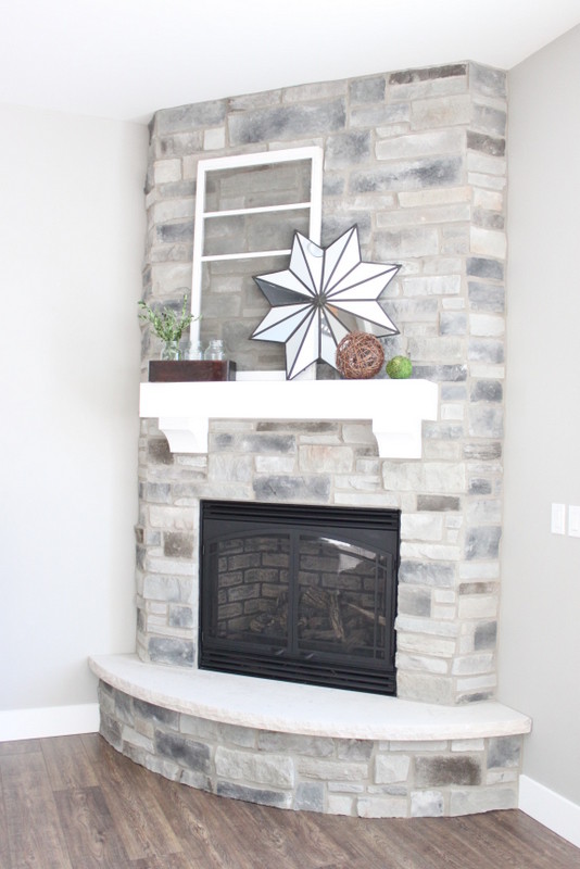 Mid-sized arts and crafts living room photo in Other with gray walls, a corner fireplace, a stone fireplace and no tv