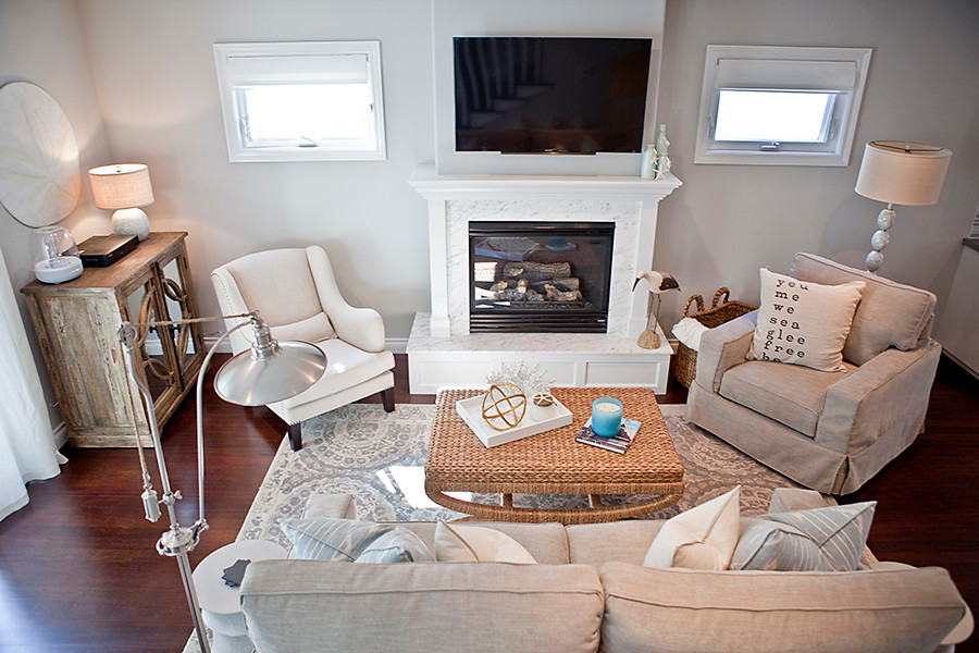 Example of a mid-sized beach style formal and open concept dark wood floor living room design in San Diego with gray walls, a standard fireplace, a stone fireplace and a wall-mounted tv