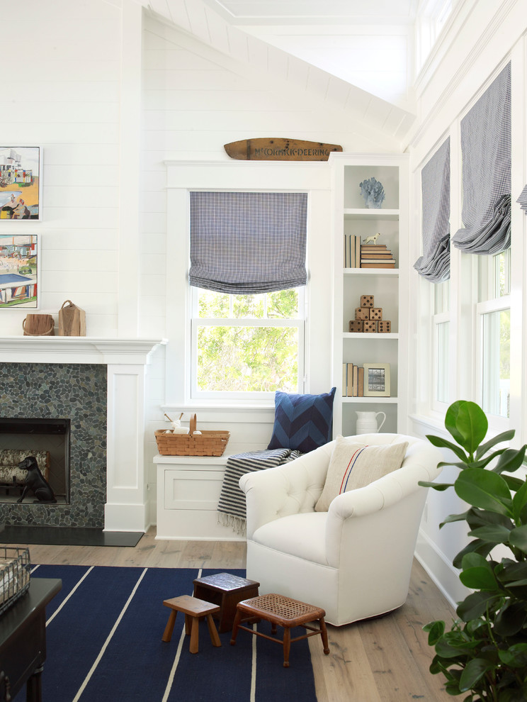 Large coastal open plan living room in San Diego with white walls, light hardwood flooring, a standard fireplace and a stone fireplace surround.