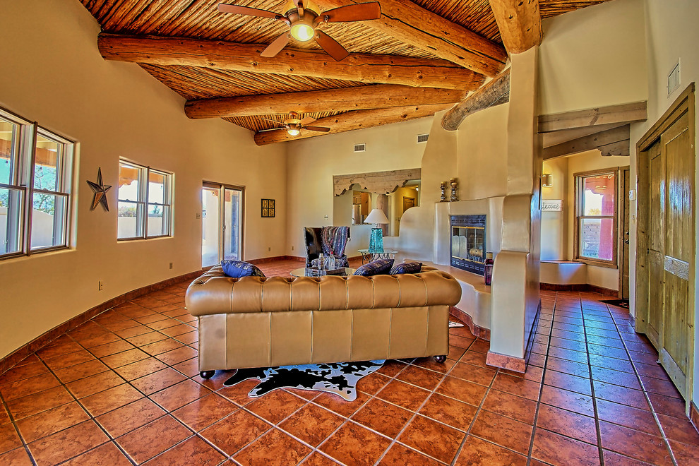 Huge southwest open concept ceramic tile living room photo in Albuquerque with beige walls, a standard fireplace and a plaster fireplace