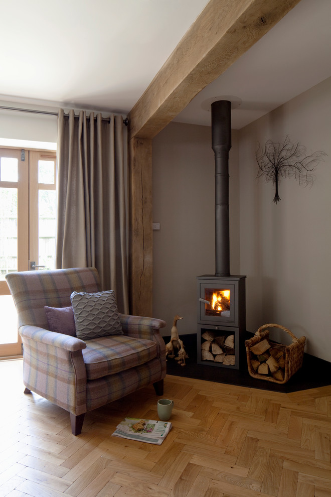 Example of an arts and crafts open concept medium tone wood floor living room design in London with a corner fireplace