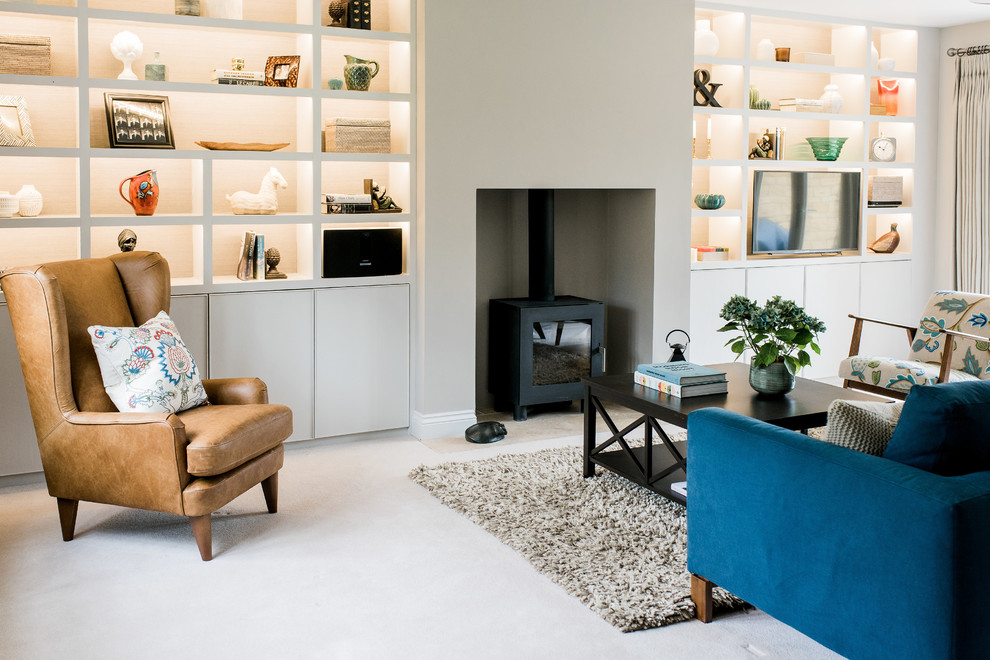 Medium sized contemporary enclosed living room in West Midlands with grey walls, a wood burning stove, a plastered fireplace surround, a wall mounted tv and white floors.