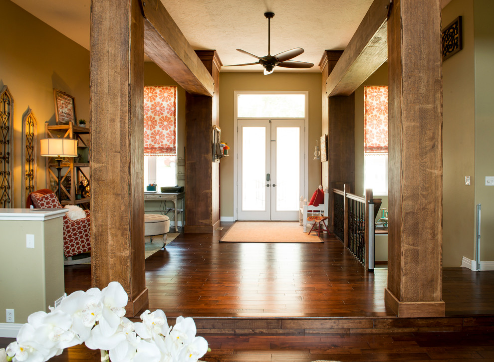 Living room - large cottage open concept dark wood floor living room idea in Other with beige walls, a standard fireplace, a stone fireplace and no tv