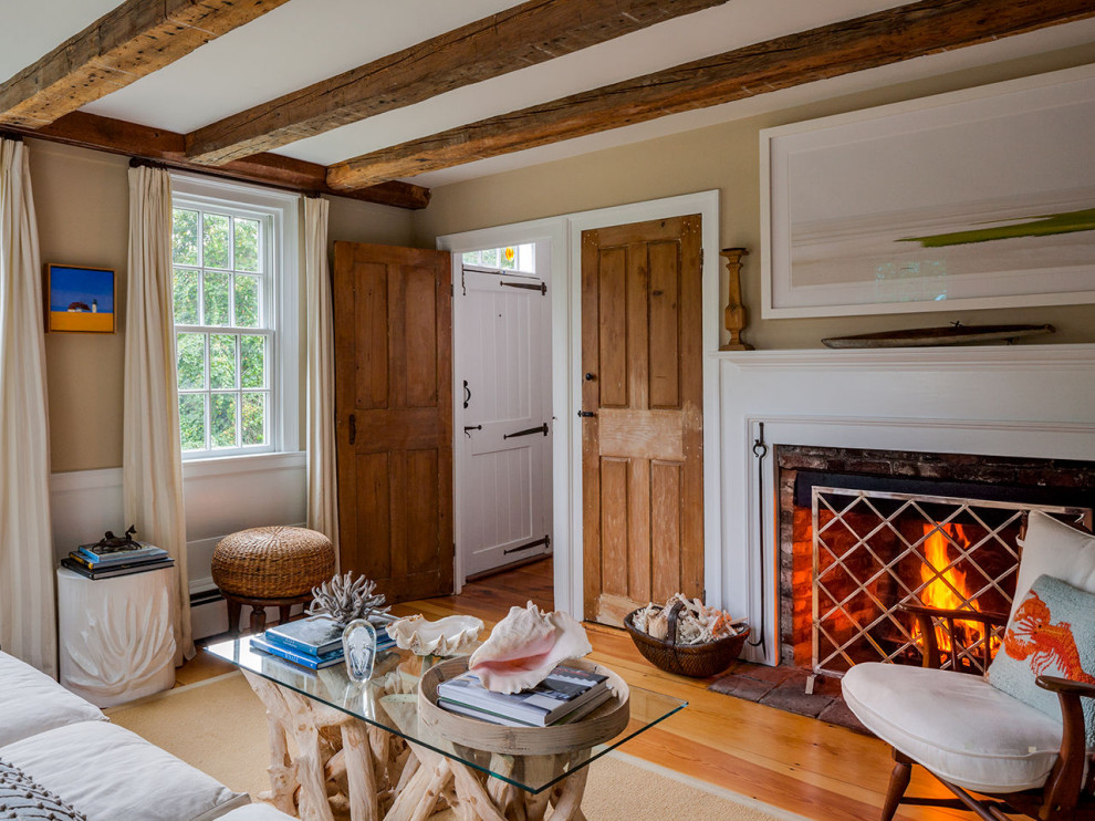 Cottage Living room with restored wooden beams & fireplace Cranberry Cottage Beach Style