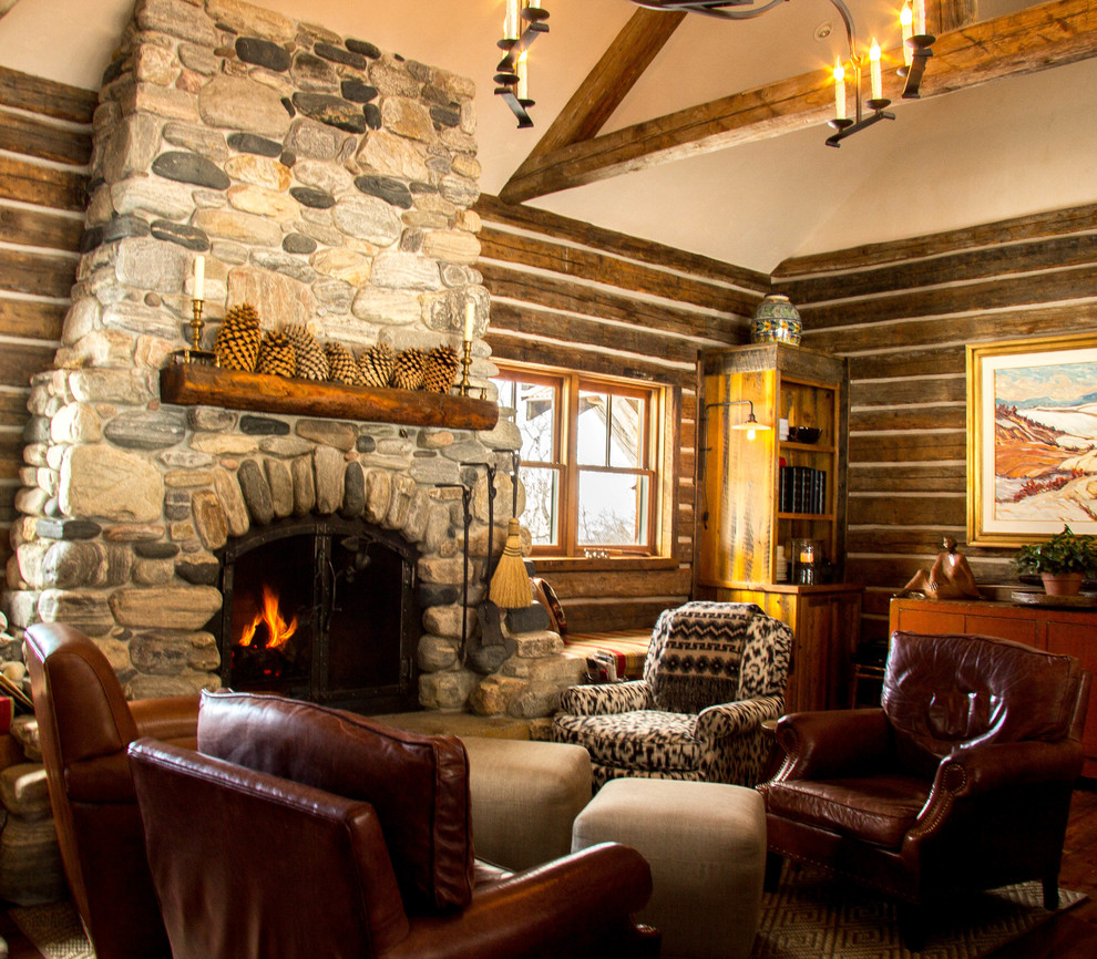 Example of a mid-sized mountain style dark wood floor living room design in Other with brown walls, a two-sided fireplace and a stone fireplace