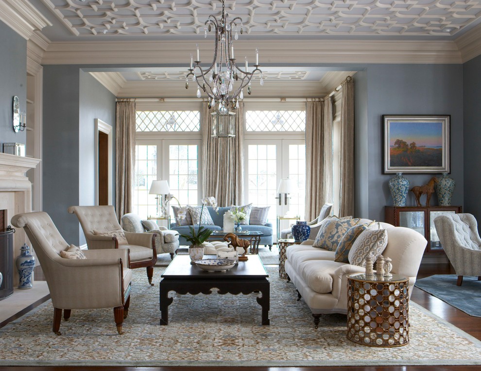 На фото: большая парадная, открытая гостиная комната:: освещение в классическом стиле с синими стенами, стандартным камином и ковром на полу с