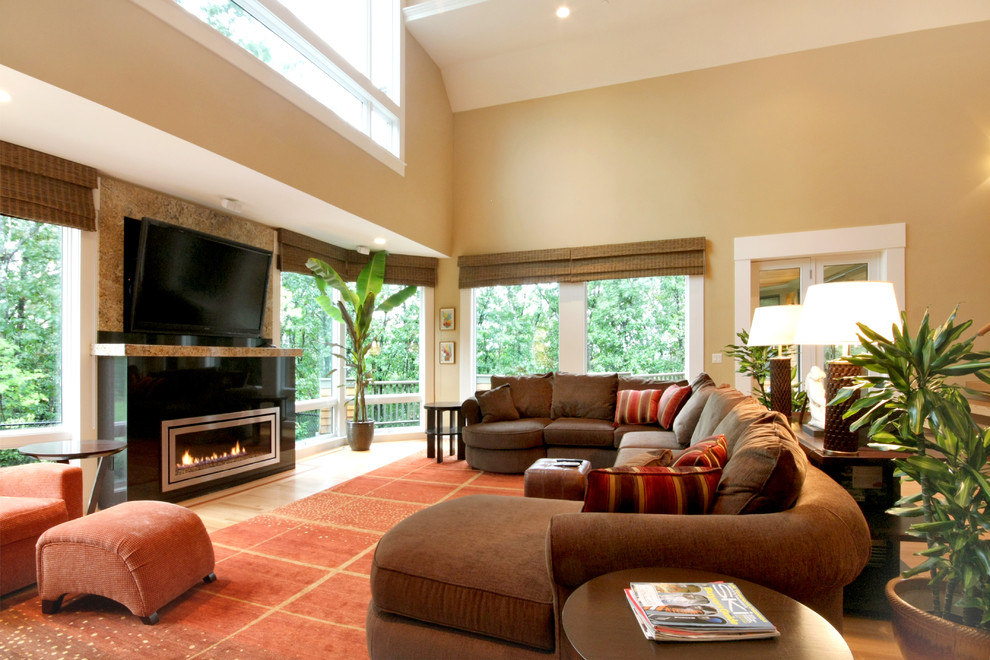 Bohemian open plan living room in Boston with a standard fireplace, a wall mounted tv, beige walls and a tiled fireplace surround.