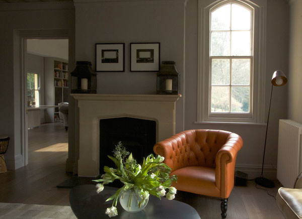Design ideas for an eclectic living room in London with beige walls, medium hardwood flooring and a standard fireplace.