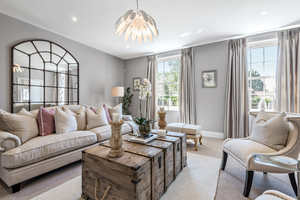 This is an example of a living room in Hampshire with grey walls, carpet and grey floors.
