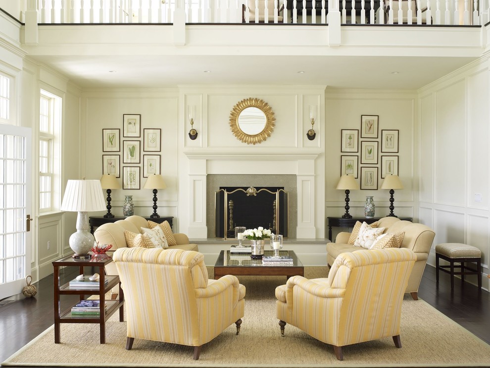 Traditional formal living room in New York with white walls, a standard fireplace, no tv and feature lighting.