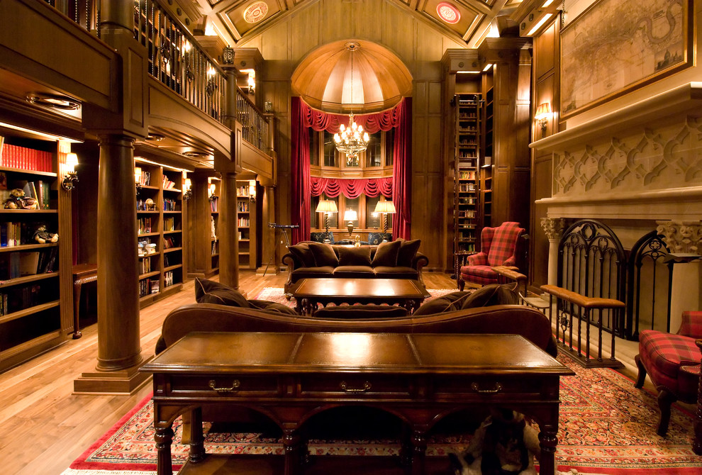 Living room library - huge traditional enclosed medium tone wood floor and brown floor living room library idea in Other with brown walls, a standard fireplace, a stone fireplace and no tv