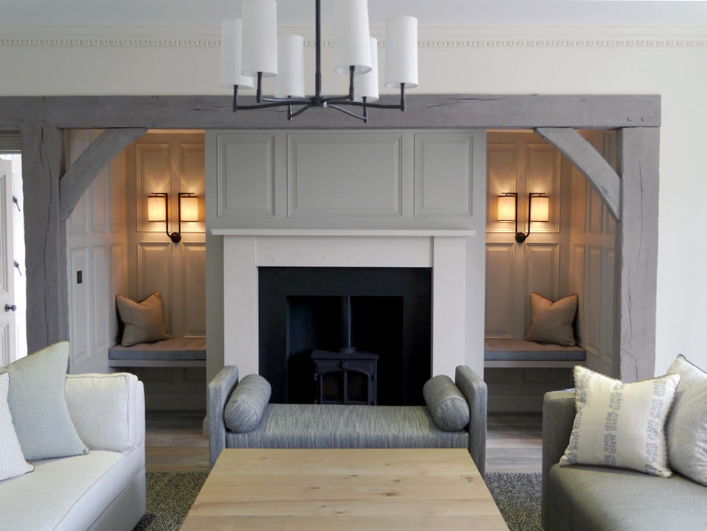 Contemporary living room in London with white walls, light hardwood flooring and a plastered fireplace surround.
