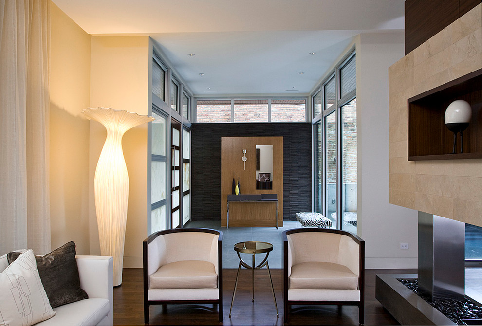 Diseño de salón actual con paredes beige, chimenea de doble cara, piedra y cortinas