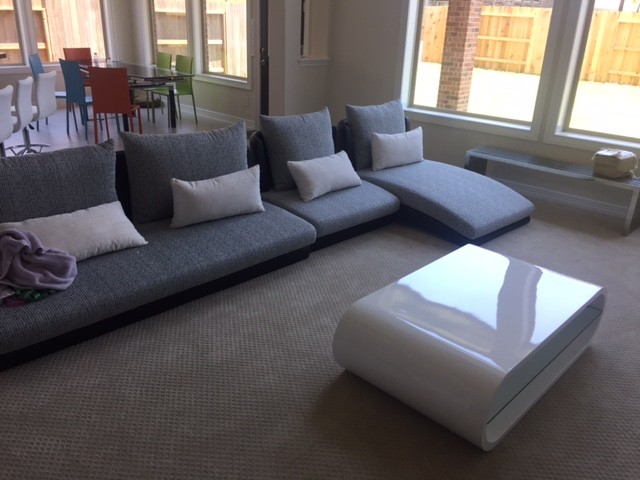 Contemporary living room in Houston with carpet.