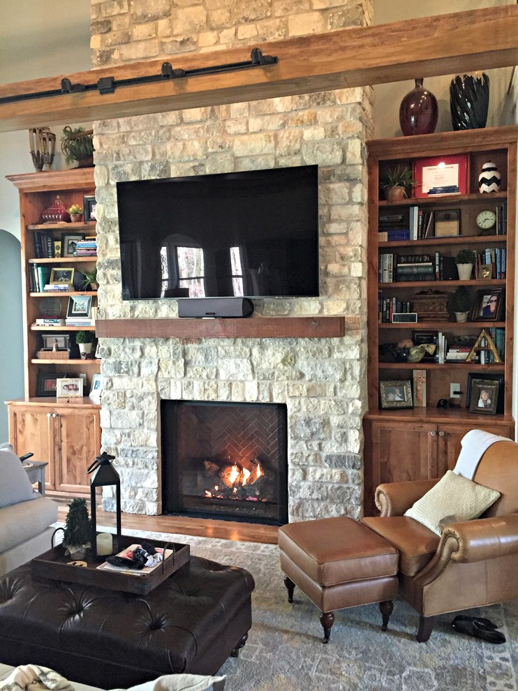 Example of a mid-sized mountain style open concept medium tone wood floor living room design in Little Rock with gray walls, a standard fireplace, a stone fireplace and a wall-mounted tv