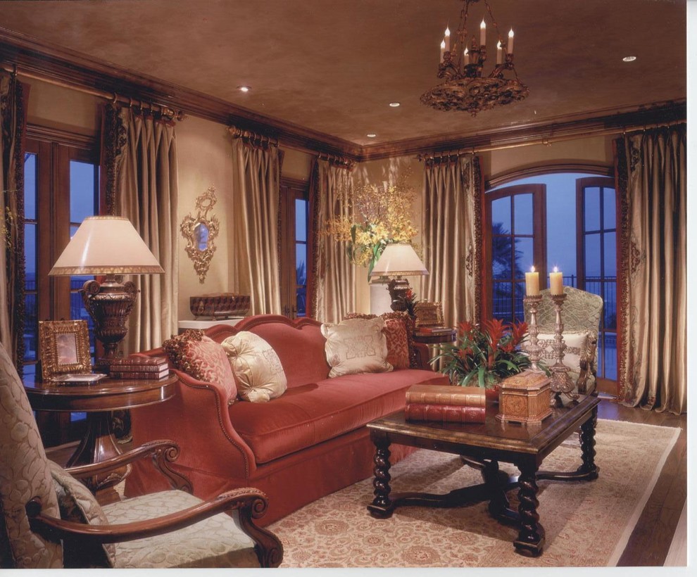 Example of a mid-sized transitional enclosed plywood floor and brown floor living room design in Orange County with beige walls, a standard fireplace, a plaster fireplace and no tv