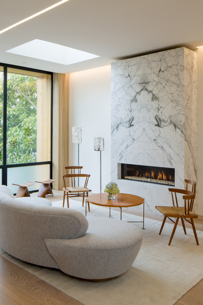 Design ideas for a contemporary open plan living room in San Francisco with white walls, light hardwood flooring and a ribbon fireplace.