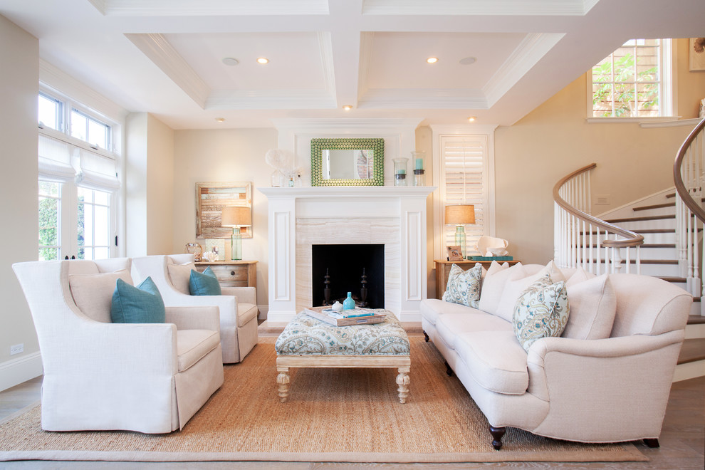 Photo of a medium sized coastal formal open plan living room in Orange County with beige walls, a standard fireplace, a tiled fireplace surround, no tv and medium hardwood flooring.